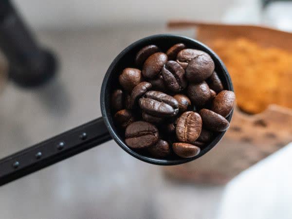 Photograph of coffee beans in a scoop